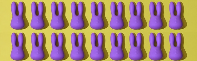 Bovenaanzicht van veel violette dildo-vibrators voor clitoris op gele achtergrond-seksspeeltjes voor volwassenen