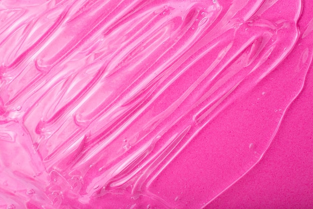 Bovenaanzicht van vloeibare cosmetica-gel met bubbelstructuur op roze achtergrond Goed als cosmetische mockup