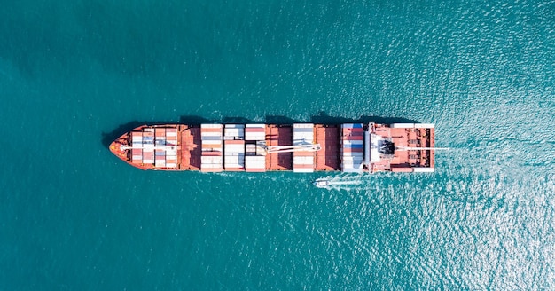 Bovenaanzicht vanuit de lucht van vrachtschip met container en rennen voor exportgoederen van vrachtwerfhaven naar aangepaste oceaanconcepttechnologie transport inklaring