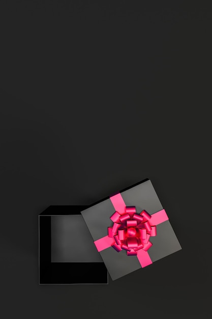 Bovenbeeld van een open zwarte cadeau doos met rood lint en boog geïsoleerd op zwarte achtergrond en kopieerruimte