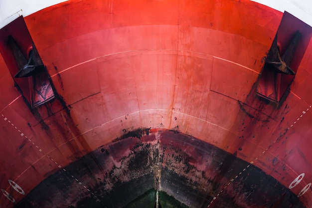 The bow of a large merchant ship with the indicated immersion depth on it and anchors front view