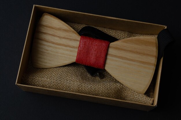 Bow tie made of handmade wood, on a black background