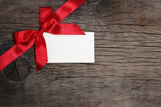 Photo bow with blank of card on grunge wood