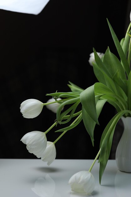 Bowed tulip buds in a bouquet on the table