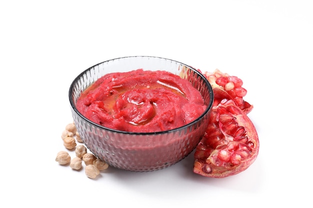 Bowl of beet hummus isolated on white background