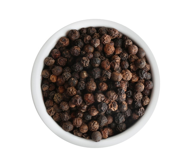 Bowl of black peppercorns isolated on white top view