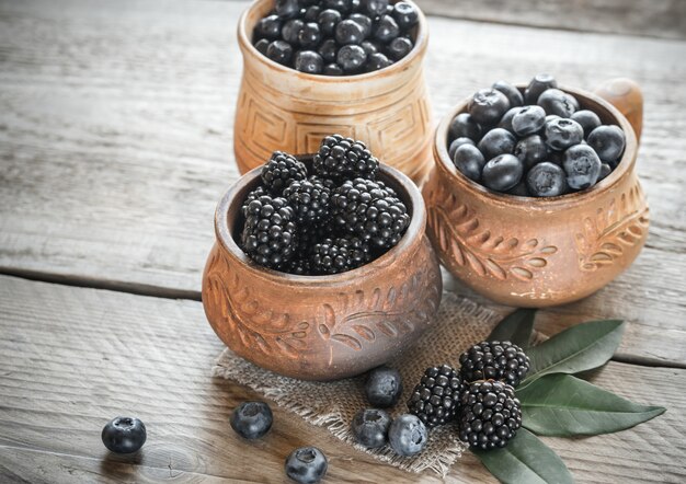 Bowl of blackberries on the wooden table