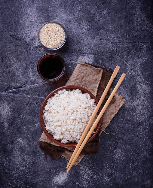 Bowl of boiled rice and chopsticks 