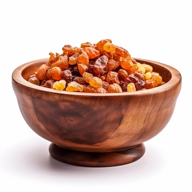 A bowl of brown colored raisins on a white background