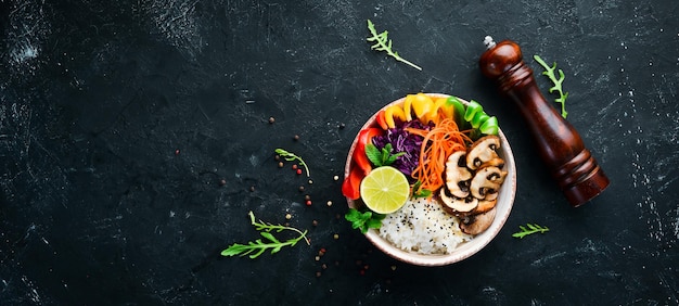 Bowl Buddha Rice with mushrooms paprika cabbage and lime Top view free space for your text