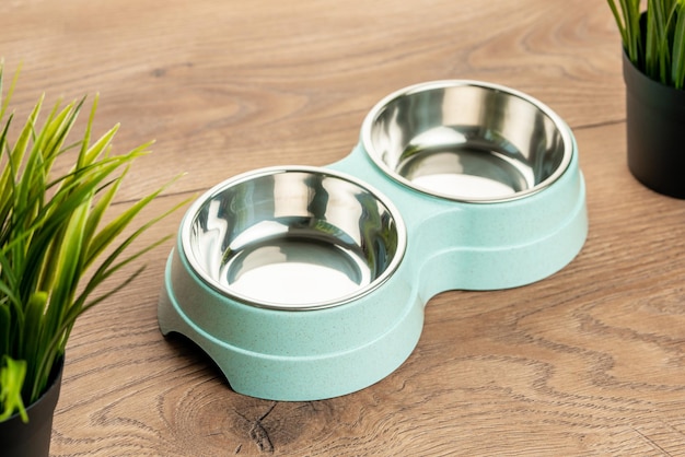 Bowl for cat food on a wooden background double bowl for water and cat food