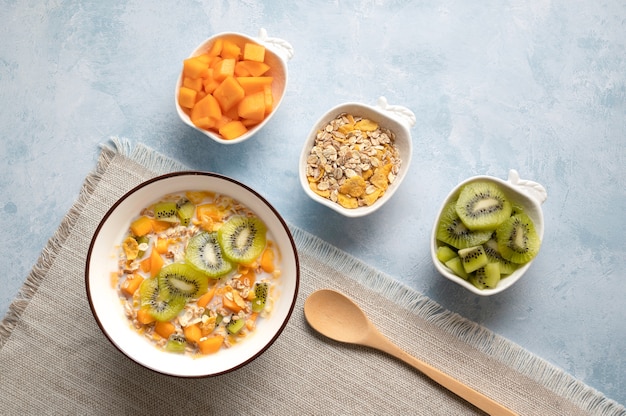 Bowl of cereals with milk and fruits delicious healthy breakfast high view