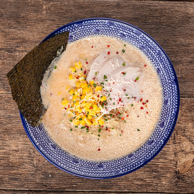 Bowl of cheese ramen noodle soup with corn