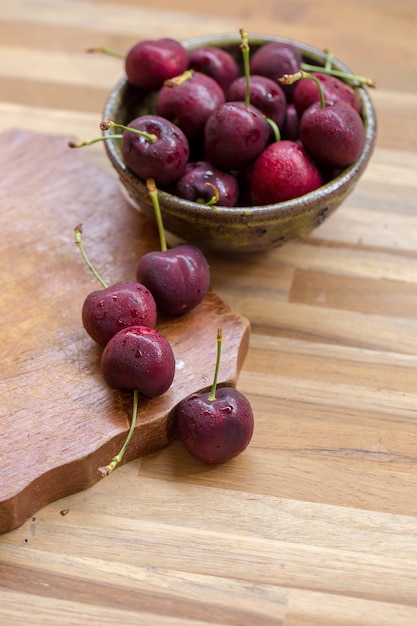 Bowl of Cherries. Red cherries in a bowl on wooden background