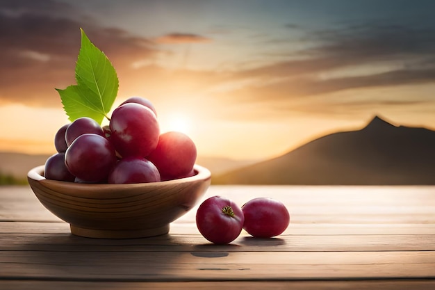 A bowl of cherries on a table with a sunset in the background