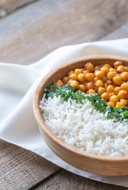 Bowl of chickpea curry with white rice and fresh cilantro