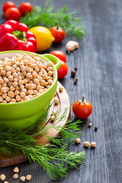  bowl of chickpeas with vegetables on a black background