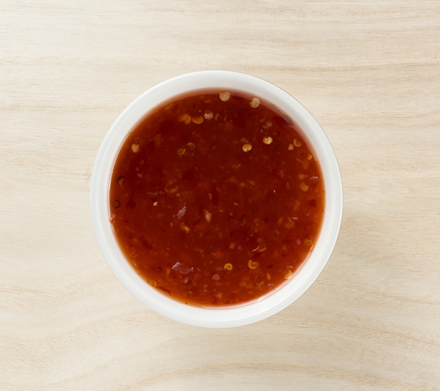 bowl of chili sauce on wood background