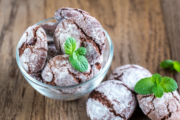 Bowl of chocolate cookies on the wooden background