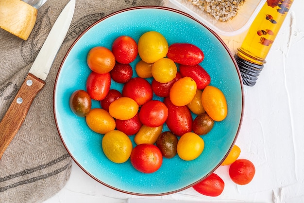 Bowl of colorful cherry tomatoes (red, garnet and yellow), fresh and raw.