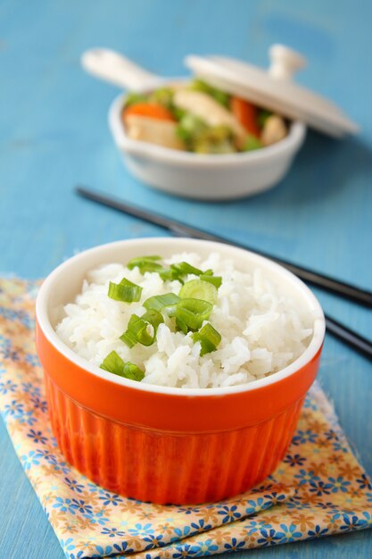 Bowl of cooked rice with green onion