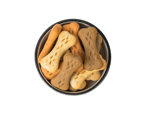 A bowl of cookies for dogs isolated on a white background A delicious treat for dogs with cereals Flat lay