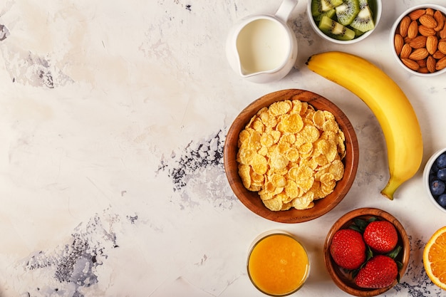 Bowl of corn flakes, berries and fruit