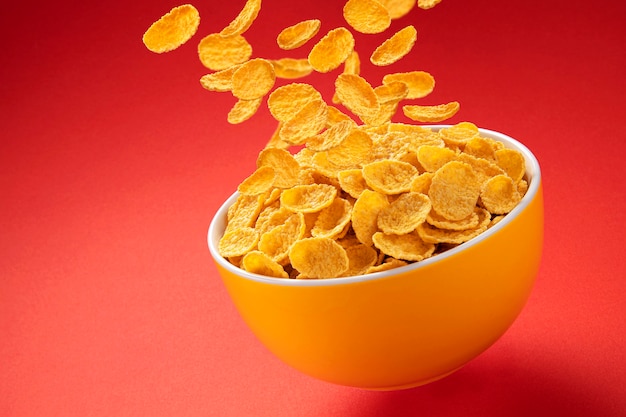 Bowl of corn flakes falling cornflakes with copy space