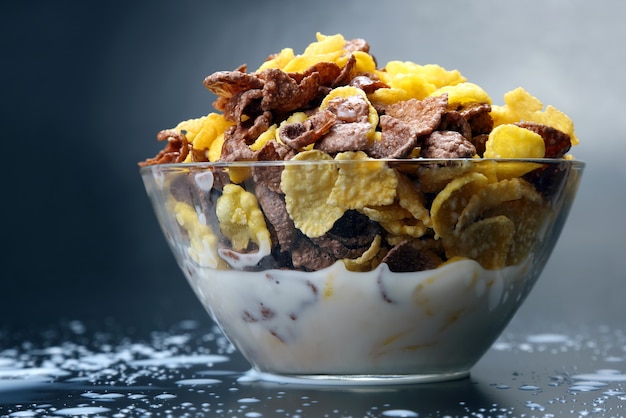 Bowl of cornflakes filled with milk
