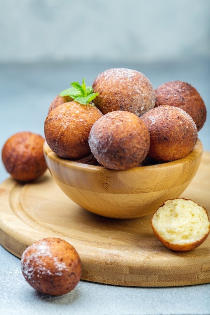 Bowl of cottage cheese with traditional donuts