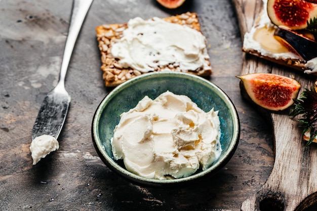 Foto ciotola di formaggio cremoso cracker al formaggio philadelphia spuntino sano sfondo ricetta alimentare primo piano