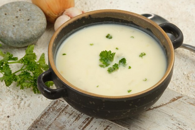 bowl of cream soup on white table