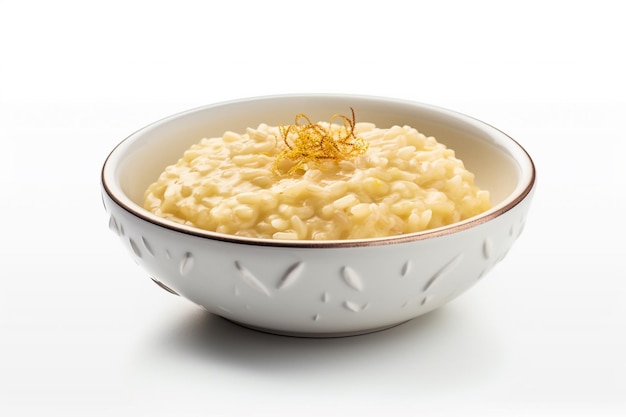 A bowl of creamy risotto with a gold leaf on top.