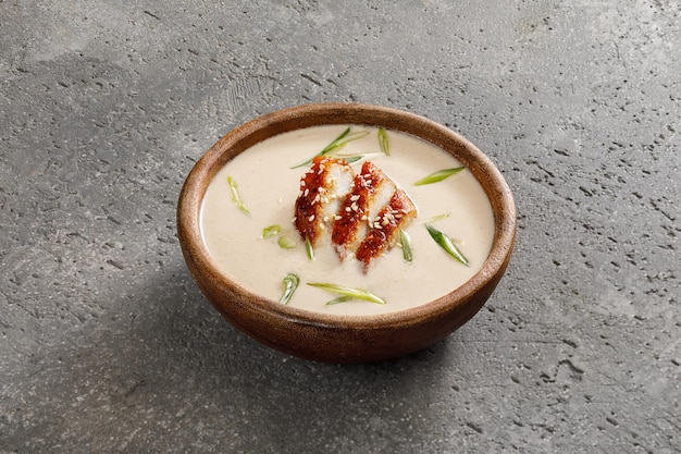 Bowl of creamy soup with eel