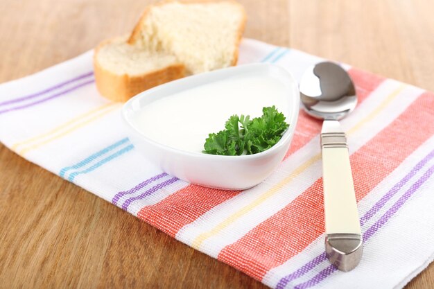 Bowl of creamy soup on wooden table