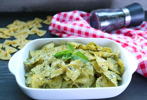 Bowl of Delectable Homemade Farfalle Pasta with Pesto Sauce on Kitchen Table