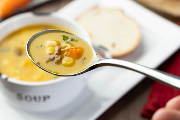 A bowl of delicious brazilian soup with beef vegetables noodles carrots and potato