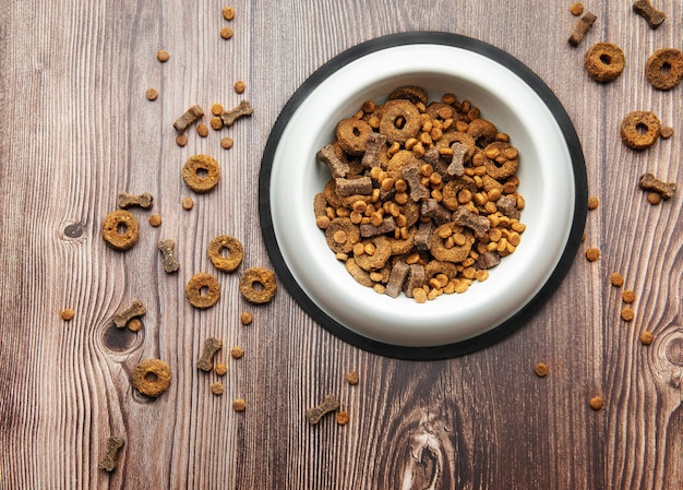 A bowl of dog food on a wooden floor