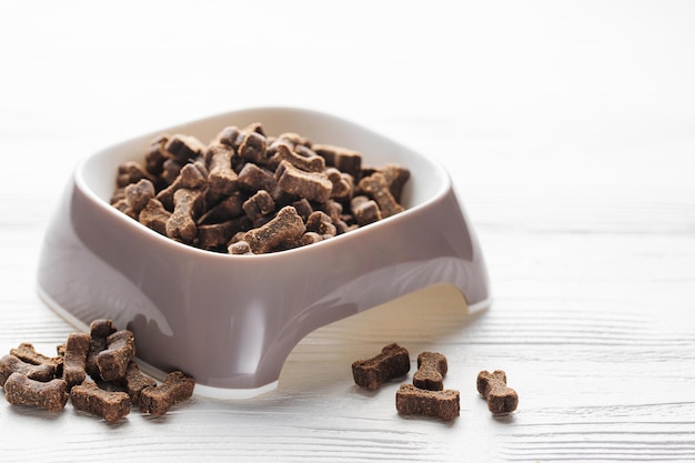 A bowl of dog food on a wooden floor