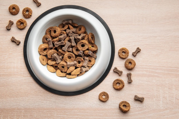 A bowl of dog food on a wooden floor