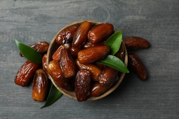 Bowl of dried dates on gray textured background