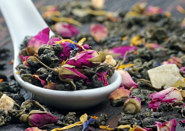 A bowl of dried flower petals sits on a table.