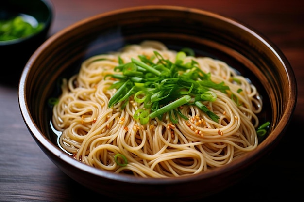 a bowl filled with noodles and green onions