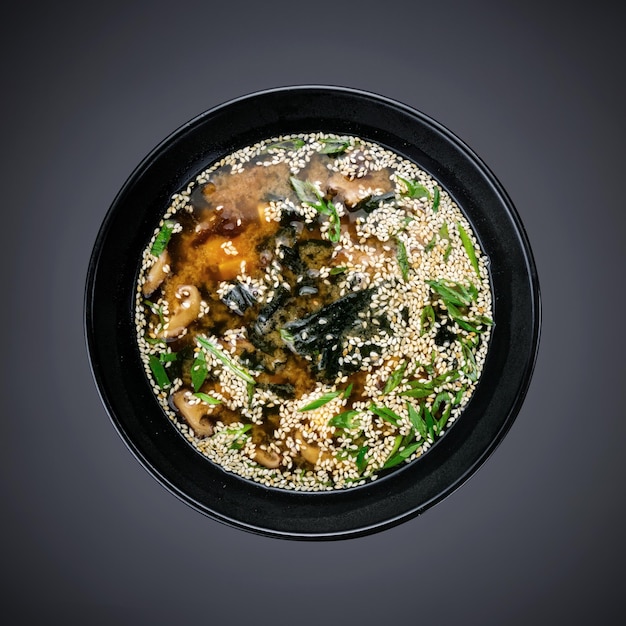 A bowl of food with a black bowl of food on it