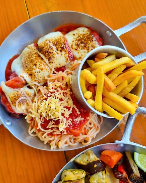 A bowl of food with a bowl of food next to it