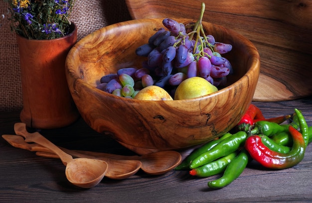 A bowl of food with a bowl of vegetables and a bowl of fruit.