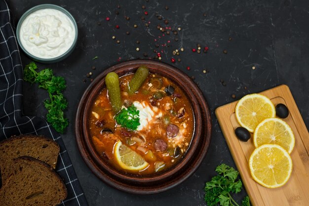 A bowl of food with bread and a plate of bread on a table