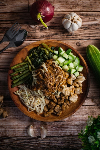 A bowl of food with a spoon next to it