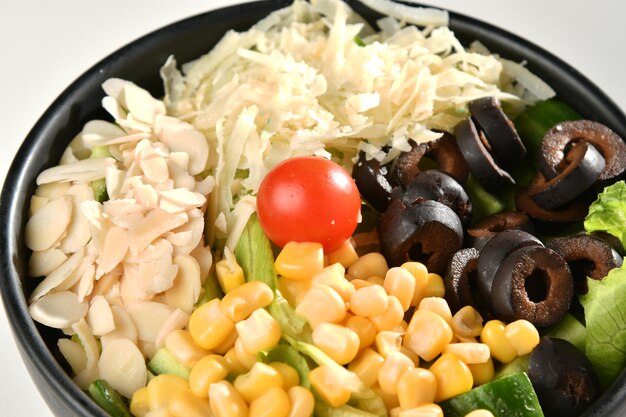 A bowl of food with a tomato on it