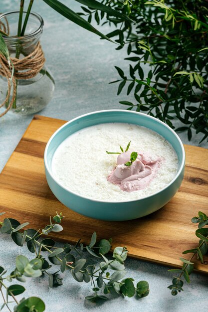 Bowl of fresh curd with mousse on the decorated background